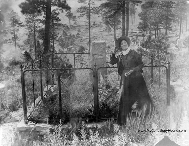 Martha Jane Cannary, better known as "Calamity Jane", posing at the grave of James Butler "Wild Bill" Hickok